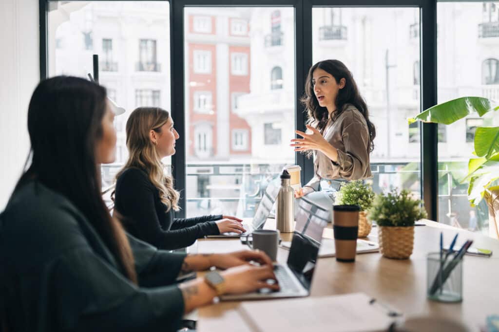 team discussion with focus on leader woman in a bright office