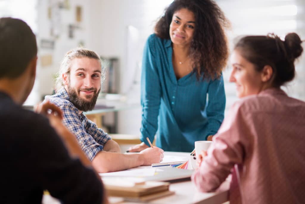 office meeting. A woman speaks with her colleagues with active listening and empathy.