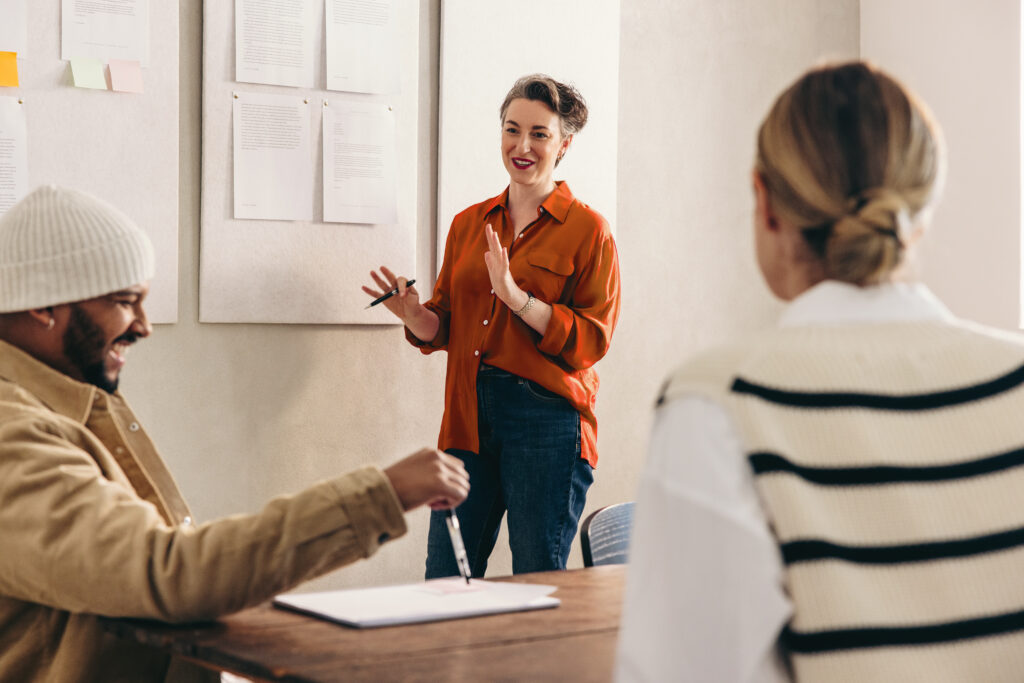 happy businesswoman giving a presentation to her team