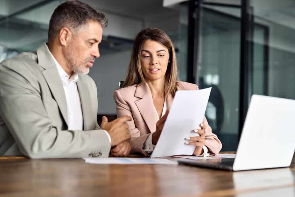 business woman manager consulting man client showing documents at meeting.